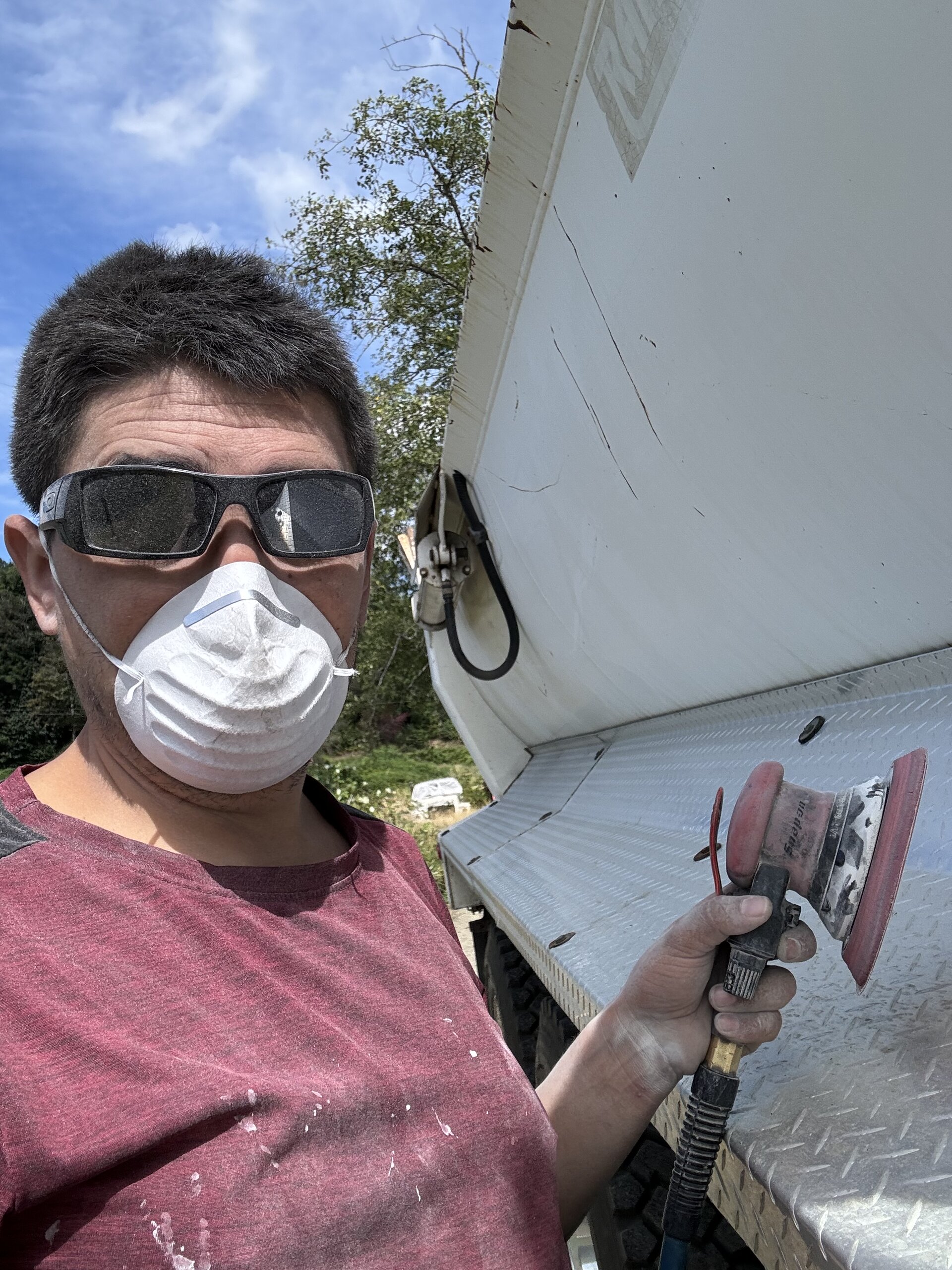 Sanding a dump bed for paint